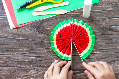 Low section of person holding multi colored umbrella