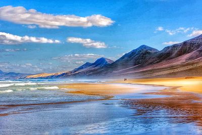 Scenic view of mountains against cloudy sky