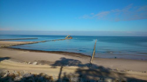 Scenic view of sea against clear blue sky