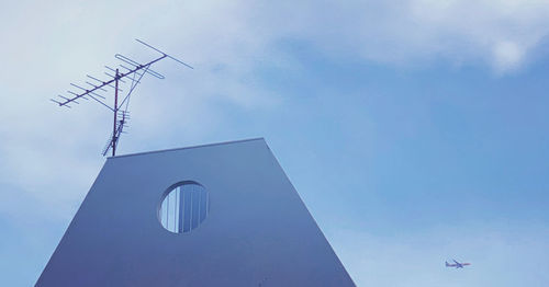 Low angle view of communications tower against sky