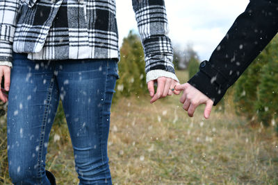 Midsection of couple standing in water