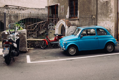 Cars on street against buildings in city