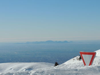 Scenic view of snowcapped mountains against clear sky