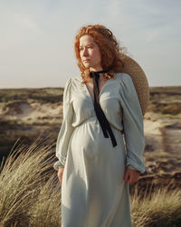 Young woman standing on field