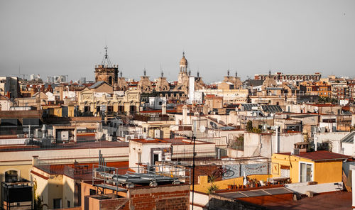 High angle view of buildings in city against clear sky