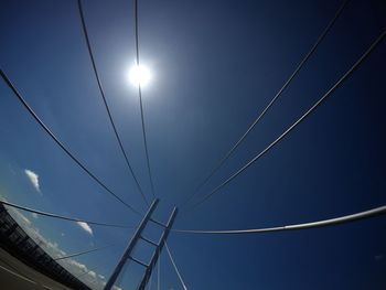 Low angle view of cables against blue sky