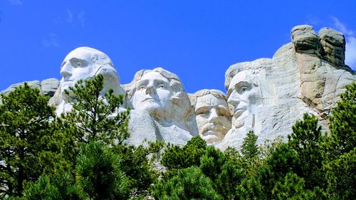 Low angle view of statue against clear blue sky