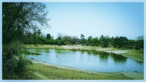 Scenic view of calm lake against clear sky