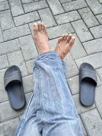 Jeans and slippers on the floor, june 2021, sidoarjo, east java, indonesia
