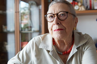 Portrait of senior woman wearing eyeglasses at home