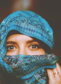 Close-up portrait of woman covering face