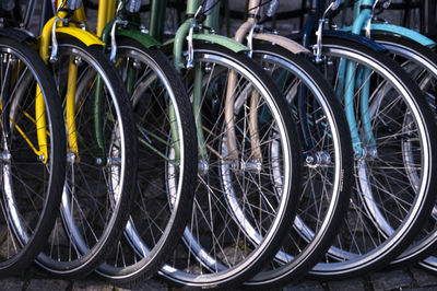 Close-up of bicycle wheel in row