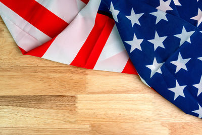 Close-up of flag against wooden wall