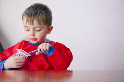 Portrait of boy holding red ball