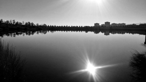 Scenic view of lake against sky on sunny day