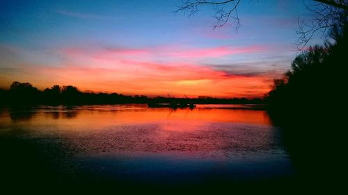 Scenic view of lake at sunset