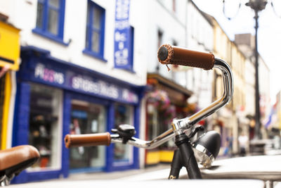 Close-up of bike handle bars on street in cork