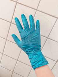 High angle view of human hand on tiled floor