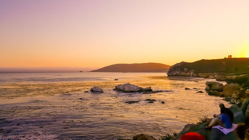 Scenic view of sea against clear sky during sunset