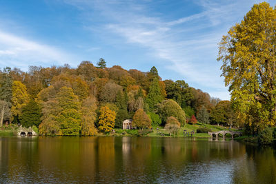 View of the autumn colours around the lake at stourhead gardens in wiltshire.