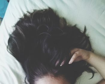 High angle view of woman lying on bed