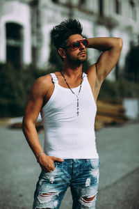 Young man wearing sunglasses standing outdoors