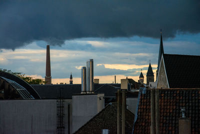 View of cityscape against dramatic sky