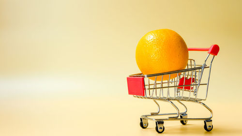 Close-up of orange fruit against white background