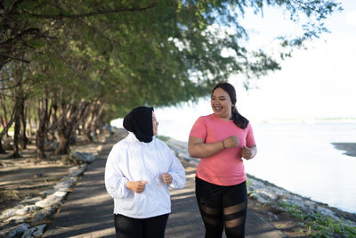 Rear view of woman walking on footpath