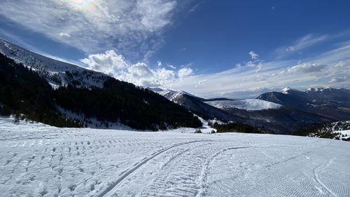 Scenic view of snow covered mountains against sky