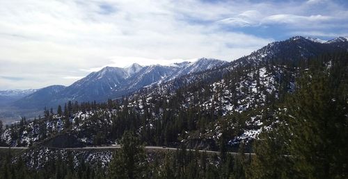 Scenic view of mountains against cloudy sky