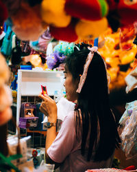 Side view of woman looking at camera