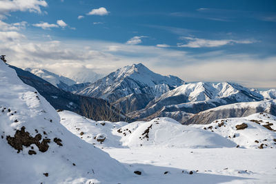 Scenic view of snow covered mountains against sky