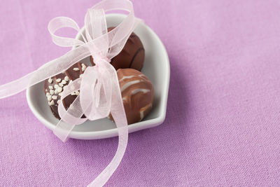 High angle view of chocolates in bowl on table