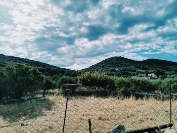 Scenic view of mountains against cloudy sky