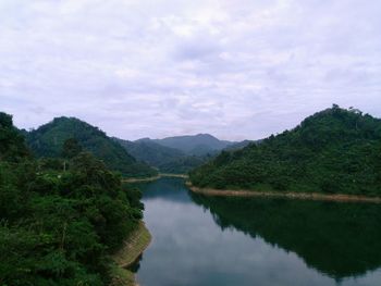 Scenic view of lake and mountains against sky