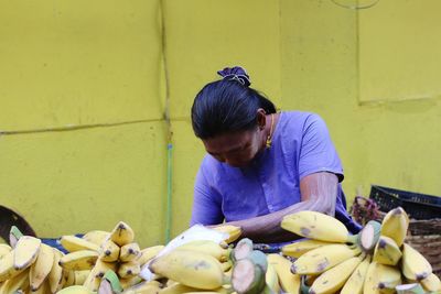 Mature woman sitting at market stall