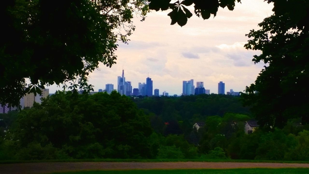 VIEW OF CITY AGAINST CLOUDY SKY