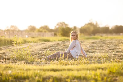 Portrait of woman sitting on field