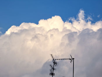 Low angle view of silhouette telephone pole against sky during sunset