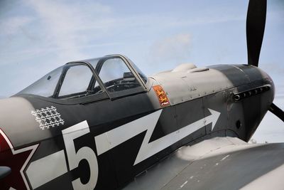 Close-up of airplane against sky