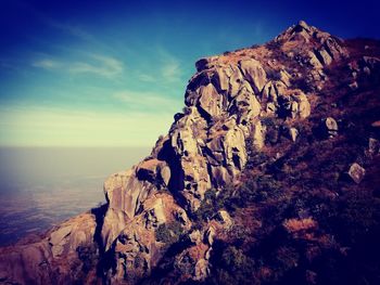 Rock formations on landscape against sky