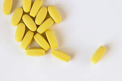 Directly above shot of yellow slices on white background