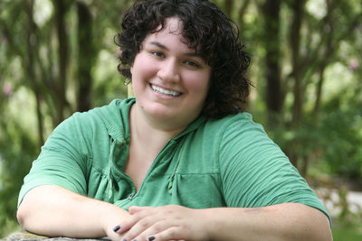 Portrait of smiling girl sitting outdoors