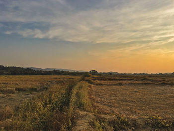 Scenic view of land against sky during sunset