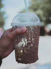 Close-up of hand holding drink