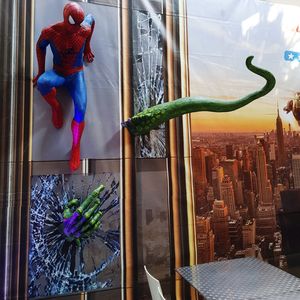 Flowers hanging on glass window by building