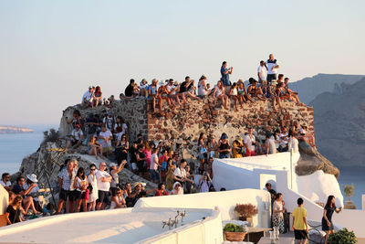 People at seaside against sky