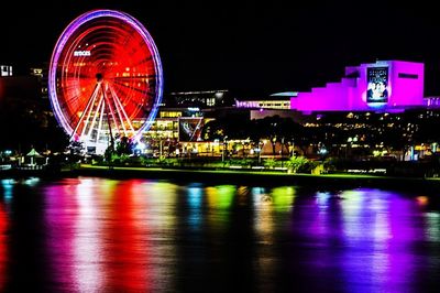 Illuminated ferris wheel at night