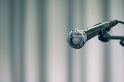 Close-up of microphone against wall